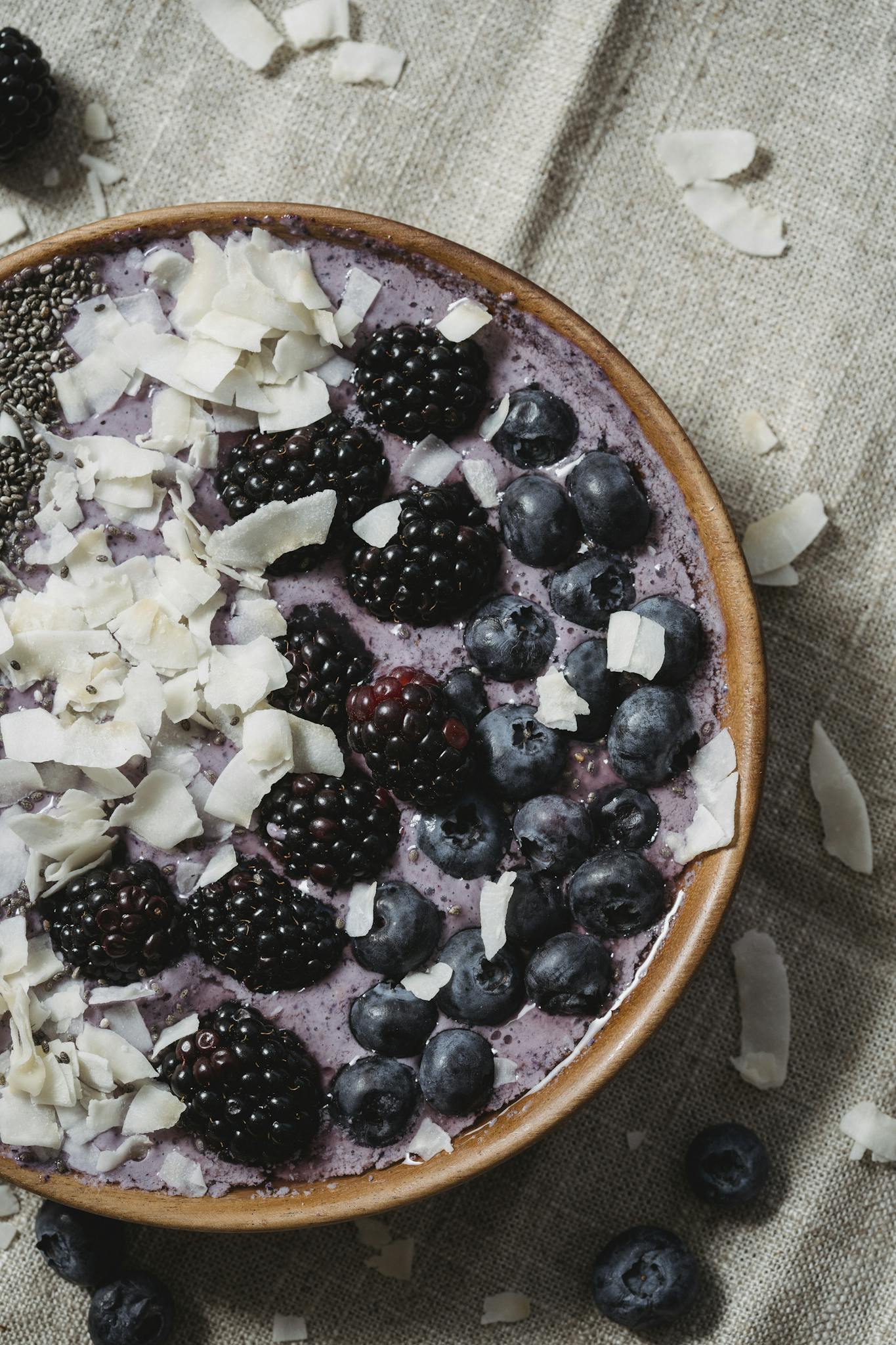 Delicious smoothie bowl topped with blackberries, blueberries, chia seeds, and coconut flakes.