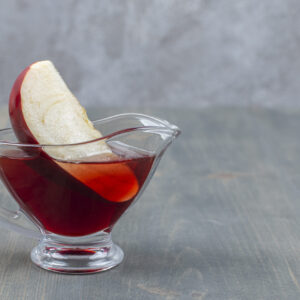 Sliced and whole red apple with juice
