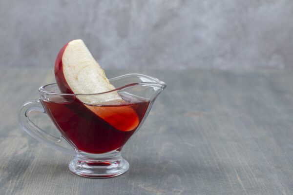 Sliced and whole red apple with juice